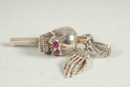 A SILVER SKULL WATCH KEY.