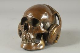 A BRONZE SKULL with headphones.