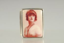 A STERLING SILVER PILL BOX the lid with a young lady. 1.25ins x 1in.