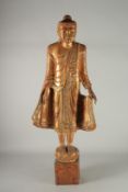 A LARGE ASIAN CARVED WOOD FIGURE. 37ins high on a base.