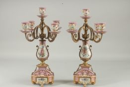 A PAIR OF SEVRES DESIGN FIVE LIGHT CANDLESTICKS with scrolling branches. 16ins high.