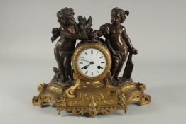A 19TH CENTURY FRENCH BRONZE AND ORMOLU CLOCK the cover with two cherubs. 11ins high.
