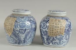 A PAIR OF CHINESE BLUE AND WHITE GINGER JARS AND COVERS 9.5ins high.