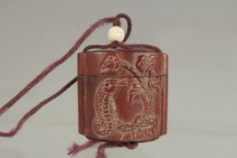 A SMALL CARVED WOOD INRO with rope. 1.75ins.