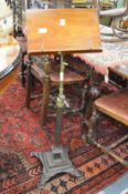 A Victorian adjustable music stand with cast metal base.