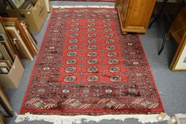 A red ground Bokara carpet 190cm x 130cm.