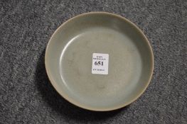 A Chinese celadon glazed shallow circular brush washer.