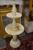 A carved alabaster two tier fountain.
