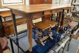 A 19th century French fruit wood plank top single drawer side table.