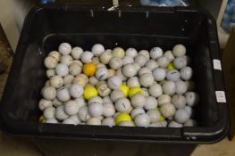 A large tub of assorted golf balls.