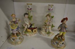 A pair of Continental porcelain figures of a boy and a girl, bears Meissen blue cross mark to the