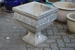 A good pair of composite garden planters of square pedestal form with moulded floral decoration.