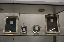 Four various silver photograph frames.