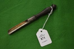 A silver apple corer with turned wood handle.