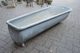 A large galvanised bath tub/planter.