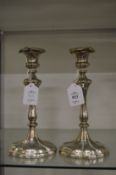 A pair of silver plated candlesticks.