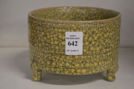 A Chinese crackle glaze circular censer on three feet.