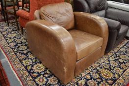 A brown leather upholstered armchair.