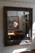 A large decoratively framed mirror.
