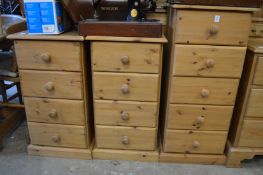 A tall narrow pine five drawer chest and a pair of similar four drawer chests.