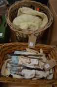 Basket containing ladies leather gloves, glove stretchers, together with another basket.