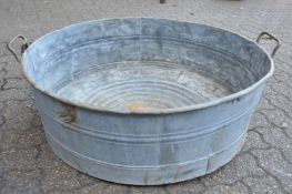 An unusual large galvanised circular twin handled garden planter.