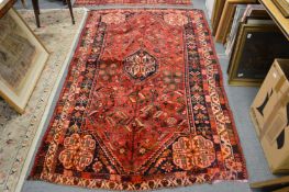 Persian design carpet red ground with stylised floral decoration (one end trimmed) 240cm x 145cm.