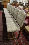 A set of eight oak framed and upholstered dining chairs.