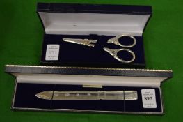 A Hallmark silver letter opener, cased and a cased pair of grape scissors.