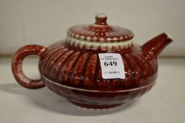 A Chinese red glaze pottery teapot.