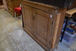 A pine two door cupboard.