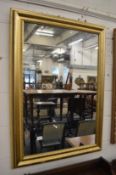 A gilt framed wall mirror.