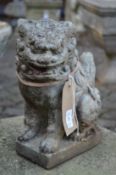 Two Chinese style lion dog garden ornaments.
