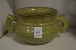 A Chinese celadon crackle glaze twin handled pottery censer.