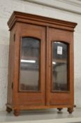 A miniature mahogany display cabinet or wardrobe.