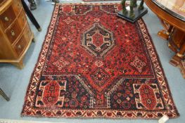 A Persian design carpet, red ground with stylised decoration 230cm x 160cm.