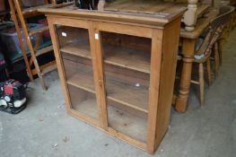 A pine two door hanging cupboard.
