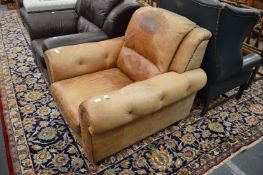 A brown leather upholstered armchair.