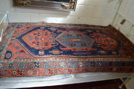 A Persian carpet, blue ground with stylised decoration 185cm x 110cm.