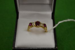 A good 18ct gold ring set with three rubies and two diamonds size T.