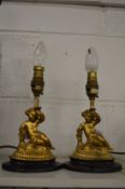 A pair of small gilt cherub table lamps.