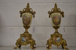 A pair of decorative ormolu and porcelain urns.
