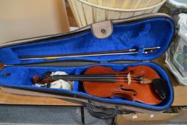 A cased violin and bow.