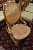 A Victorian cane work upholstered rocking chair.