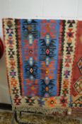 A small flat weave kilim rug, central blue ground with stylised decoration 155cm x 80cm.