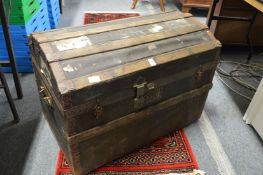 A dome topped trunk and a metal trunk.