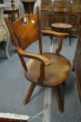 An Edwardian oak office swivel armchair.