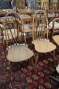 A pair of spindle back dining chairs.