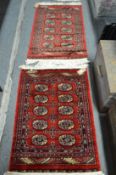 Two small Bokara rugs 95cm x 67cm and 105cm x 63cm.