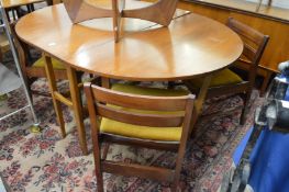 A teak drop leaf gateleg dining table with four dining chairs.